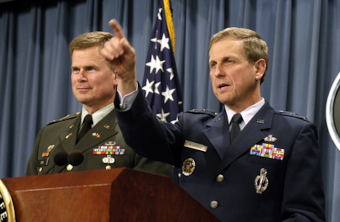 Maj. Gen. Franklin J. Blaisdell (right), U.S. Air Force, director for Space Operations and Integration, recognizes a reporter for a question during a Pentagon press briefing on March 12, 2003. Blaisdell and Col. Steven Fox, U.S. Army, of Army Space Support, briefed reporters on a broad range of benefits from our space-based technologies including precision navigation and targeting, weather forecasting and voice and data communications. 
