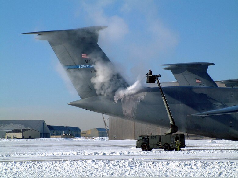 WESTOVER AIR RESERVE BASE, Mass. -- Maintainers spray de-icer on a C-5 Galaxy after snowfall and a sudden plunge in temperatures March 7 left ice everywhere on Westover Air Reserve Base, Mass. The storm dropped 4.2 inches of snow, bringing the total for the season to 84 inches. (U.S. Air Force photo by Master Sgt. W.C. Pope)
