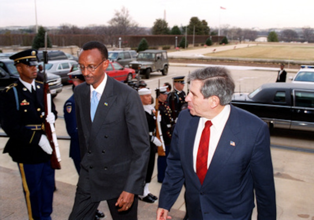 Deputy Secretary of Defense Paul Wolfowitz (right) escorts Rwandan President Paul Kagame into the Pentagon on March 5, 2003. The two men will meet to discuss a range of bilateral security issues. 