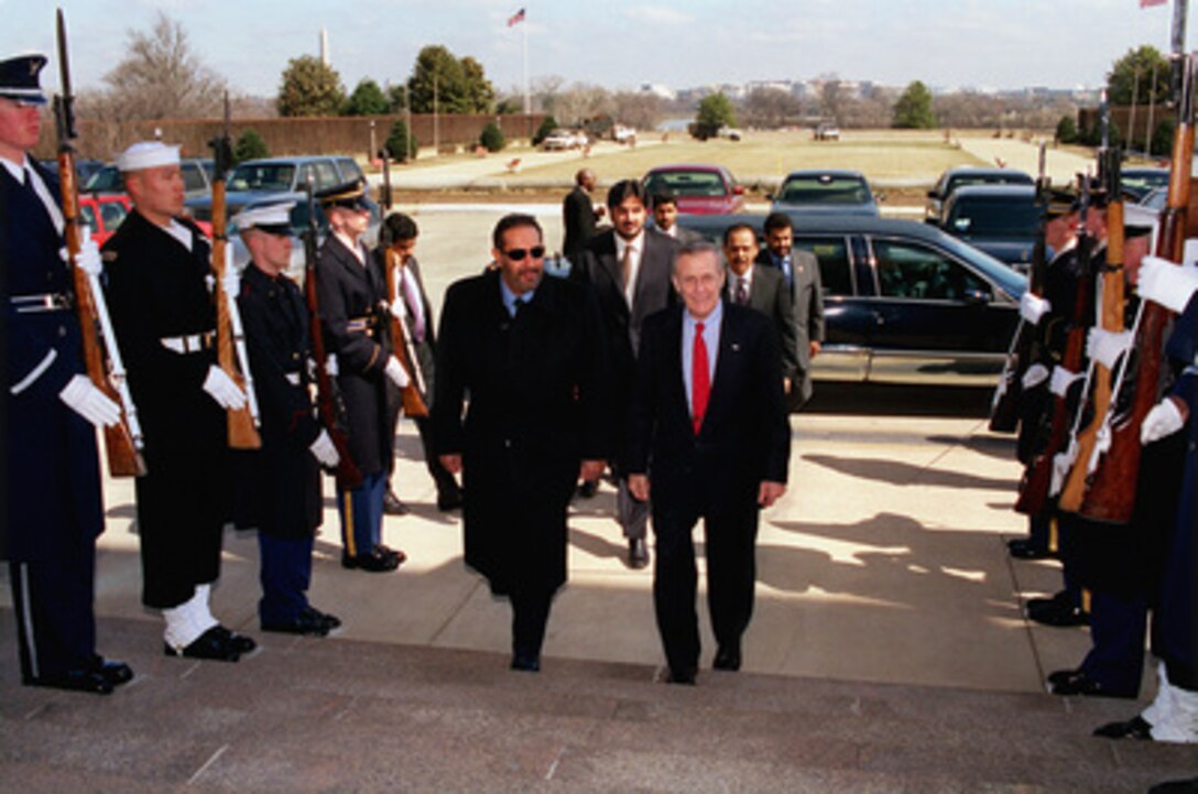Secretary of Defense Donald H. Rumsfeld (right) escorts Qatari Foreign Minister Shaikh Hamad bin Jasim bin Jabir Al Thani through an honor cordon and into the Pentagon on March 7, 2003. Rumsfeld and Thani will meet to discuss a number of bilateral security issues. 