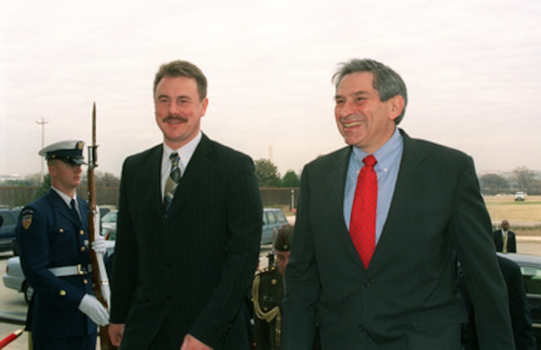 Deputy Secretary of Defense Paul Wolfowitz (right) escorts Latvian Minister of Defense Girts Valdis Kristovskis into the Pentagon on March 12, 2003. Wolfowitz and Kristovskis will meet to discuss a range of bilateral security issues. 