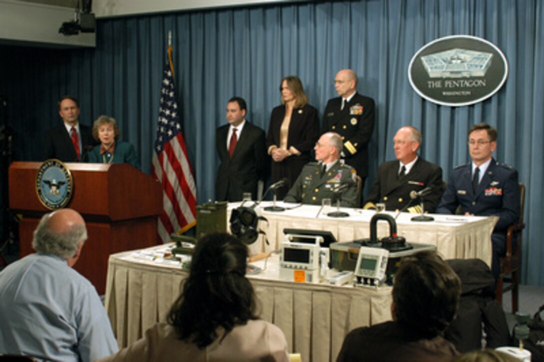 Deputy Assistant to the Secretary of Defense for Chemical and Biological Defense Anna Johnson-Winegar (second from left) discusses steps being taken to protect U.S. troops in the Persian Gulf during a Pentagon press briefing on March 13, 2003. The senior leadership of the Department of Defense medical community briefed reporters on force health protection measures being implemented. From left to right: Assistant Secretary of Defense for Health Affairs Dr. William Winkenwerder Jr.; Johnson-Winegar; Deputy Under Secretary for Health, Department of Veterans Affairs Dr. Jonathan Perlin; Deputy Assistant Secretary of Defense for Force Health Protection & Medical Readiness Ellen Embrey; Rear Adm. John Mateczun, U.S. Navy, senior medical officer, The Joint Staff; Army Surgeon General Lt. Gen. James Peake (seated); Navy Surgeon General Adm. Michael Cowan and Air Force Surgeon General Lt. Gen. George Peach Taylor. 