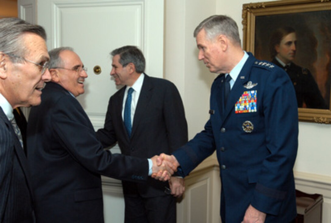 Secretary of Defense Donald H. Rumsfeld (left) introduces Turkish Minister of National Defense Vecdi Gonul (2nd from left) to Chairman of the Joint Chiefs of Staff Gen. Richard B. Myers (right) in the Pentagon on March 18, 2003. Rumsfeld, Gonul, Myers and Deputy Secretary of Defense Paul Wolfowitz (2nd from right) will meet to discuss regional security issues of interest to both nations. 