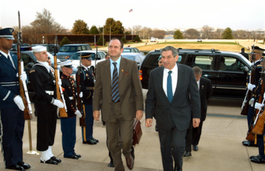 Deputy Secretary of Defense Paul Wolfowitz (right) escorts Minister of Defense Vlado Buchkovski, of the Former Yugoslav Republic of Macedonia, into the Pentagon on March 18, 2003. Buchkovski will meet briefly with Wolfowitz and then in more detailed security talks with Under Secretary of Defense for Policy Douglas Feith and Deputy Assistant Secretary of Defense for Eurasian Affairs Mira Ricardel. 