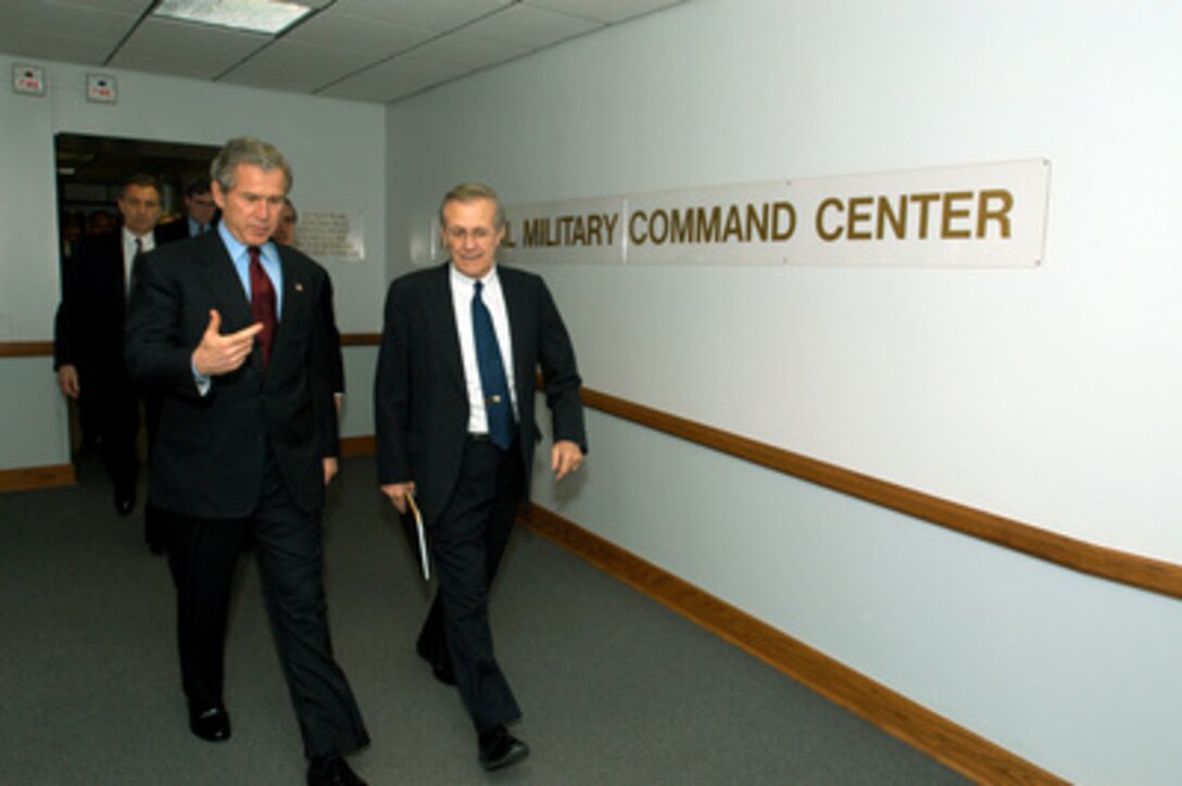 President George W. Bush (left) and Secretary of Defense Donald H. Rumsfeld walk from the Pentagon's National Military Command Center where they received operational briefings on March 25, 2003. Bush visited the Pentagon to meet with the senior defense leadership and announce his $74.7 billion wartime supplemental budget request. Once appropriated by Congress, the money will pay for the direct costs of the Iraqi conflict and the global war against terror. 