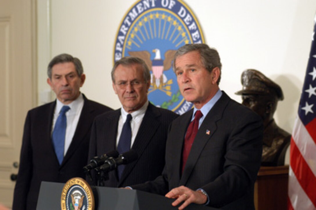 President George W. Bush (right) announces his $74.7 billion wartime supplemental budget request in the Pentagon on March 25, 2003, as Secretary of Defense Donald H. Rumsfeld (center) and Deputy Secretary of Defense Paul Wolfowitz look on. Bush visited the Pentagon to meet with the senior defense leadership and to announce the supplemental request which, once appropriated by Congress, will pay for the direct costs of the Iraqi conflict and the global war against terror. 