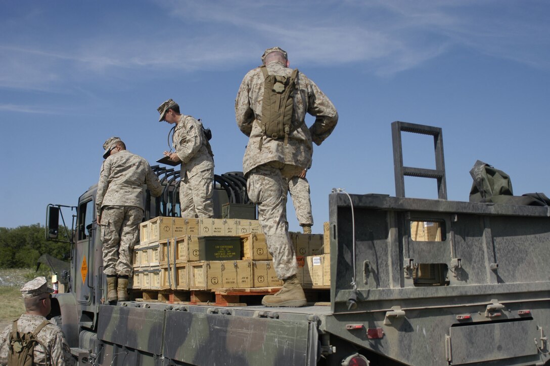 Cpl. Samantha Purdy, issue technician from General Support Ammunition Platoon, Ammunition Company, 4th Marine Logistics Group headquartered in Topeka, KS and Lance Cpl. Patrick McArthy, issue technician from Detachment 1, Ammunition Company, 4th Marine Logistics Group based in Rome, Ga. account for ammunition being loaded onto a MK-23 7-ton truck here June 9.  Reserve artillerymen from 14th Marine Regiment, 4th Marine Division used the ammunition for live-fire exercises in exercise Texas Phoenix, June 6-20.