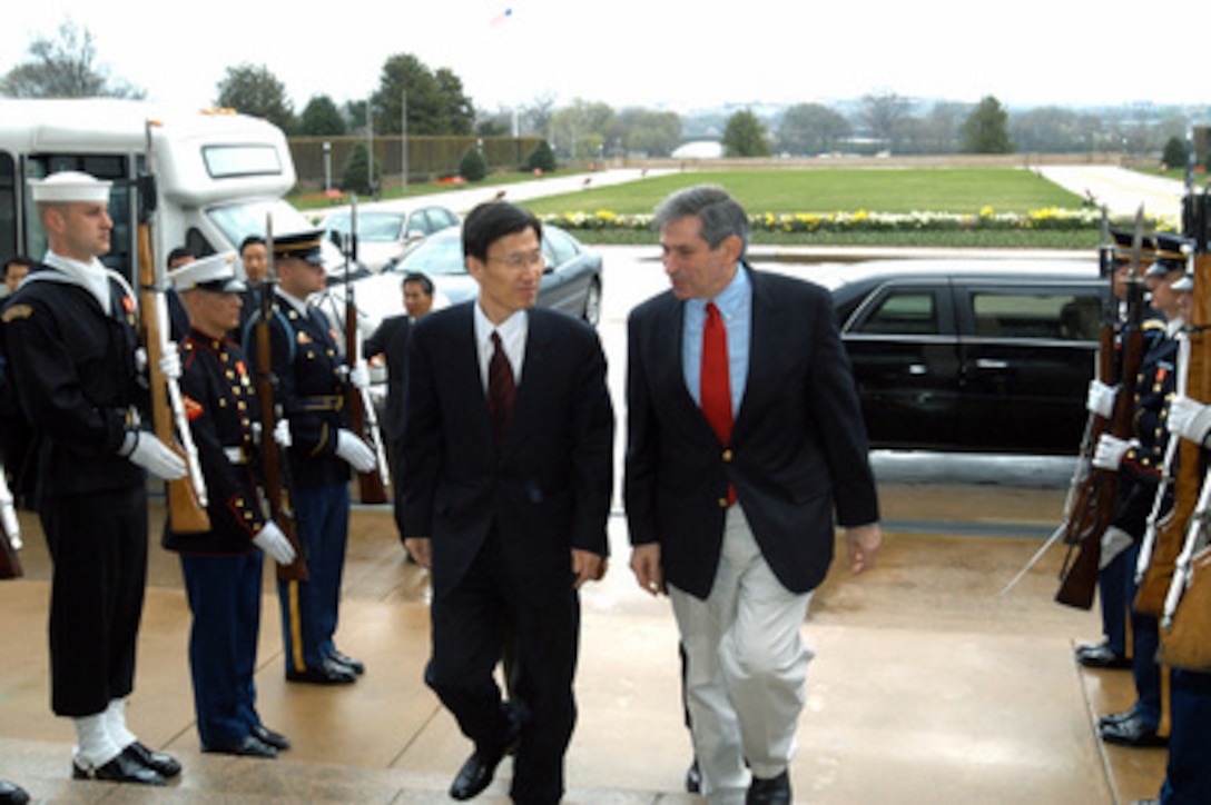 Deputy Secretary of Defense Paul Wolfowitz (right) escorts South Korean Minister of Foreign Affairs Yoon Young-kwan through an honor cordon and into the Pentagon on March 29, 2003. The two men will meet to discuss a number of bilateral security issues including the threat of North Korea's nuclear program. 