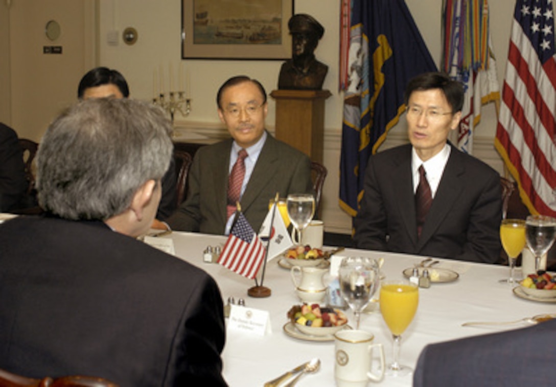 South Korean Minister of Foreign Affairs Yoon Young-kwan (right) meets with Deputy Secretary of Defense Paul Wolfowitz (foreground) in the Pentagon on March 29, 2003. The two men are discussing a number of bilateral security issues including the threat of North Korea's nuclear program. South Korean Ambassador Sung Chul Yang (center) joined in the talks. 
