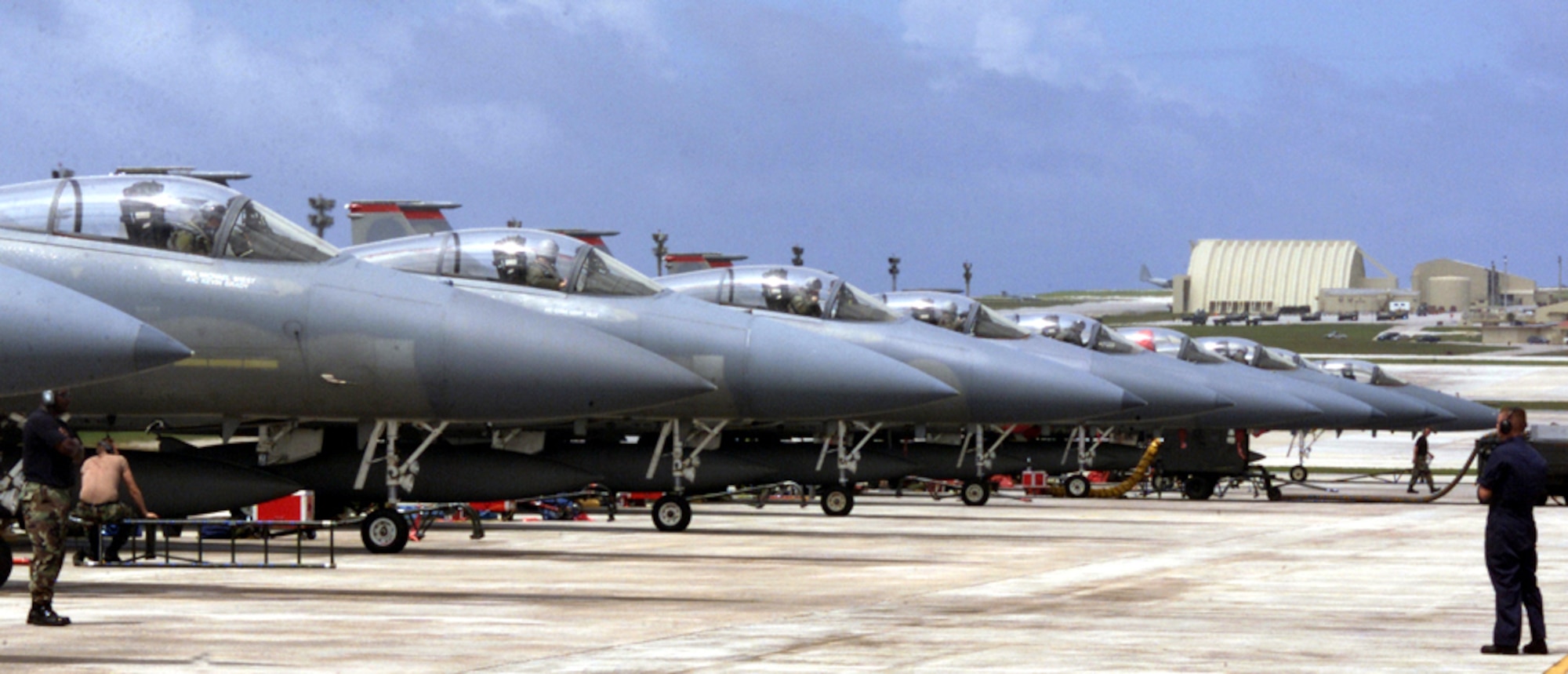 ANDERSEN AIR FORCE BASE, GUAM -- A row of F-15 Eagles, deployed from Kadena Air Base, Japan, for exercise Tandem Thrust 03, line up before takeoff April 24.  The exercise is a joint endeavor conducted in the Marianas Islands including forces from the U.S., Canada and Australia. (U.S. Air Force photo by Photo by Airman 1st Class Abby M. Young)