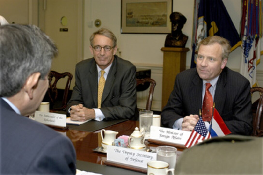 Netherlands's Minister of Foreign Affairs Jaap de Hoop Scheffer (right) meets with Deputy Secretary of Defense Paul Wolfowitz (foreground) in the Pentagon on May 1, 2003. Scheffer and Wolfowitz, along with Netherlands's Ambassador to the United States Boudewijn van Eenennaam (center) are meeting to discuss bilateral security issues of interest to both nations. 