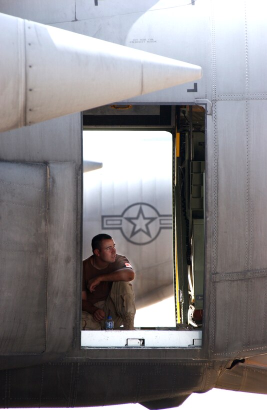 OPERATION IRAQI FREEDOM -- Staff Sgt. Paul Smith takes a break from the heat in a C-130 Hercules on the flightline at a forward-deployed location in Southwest Asia.  The C-130s arrived May 3 to help with stabilization efforts inside Iraq.  Smith is a crew chief deployed with the West Virginia Air National Guard's 130th Airlift Wing at Charleston.  (U.S. Air Force photo by Master Sgt Terry L. Blevins)