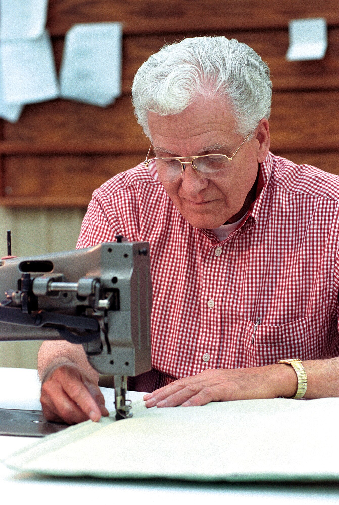 TINKER AIR FORCE BASE, Okla. -- Paul Barber sews aircraft panels during his temporary assignment to the textile and life support unit.  After 50 years of Air Force service, first in uniform then as a civilian, Barber still loves working every day.  (U.S. Air Force photo by Margo Wright)