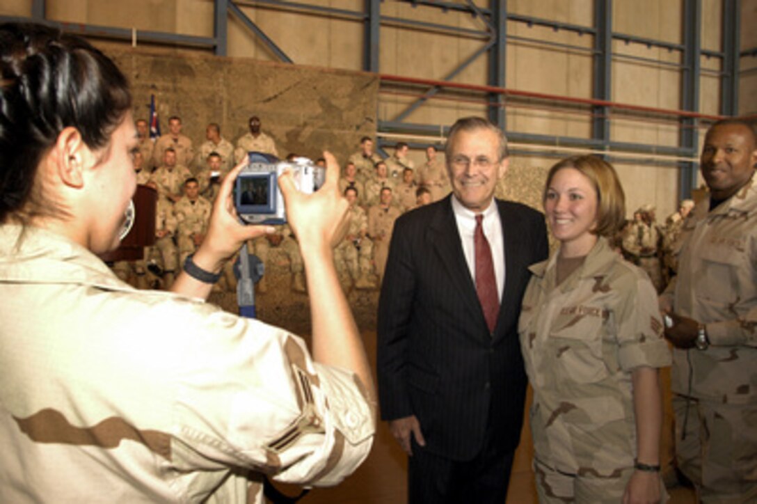 Secretary of Defense Donald H. Rumsfeld poses for photographs following a town hall meeting at Prince Sultan Air Base, Saudi Arabia, on April 29, 2003. Rumsfeld addressed the troops and then took questions from the military audience. Rumsfeld is visiting the troops and senior leadership in the Persian Gulf region. 
