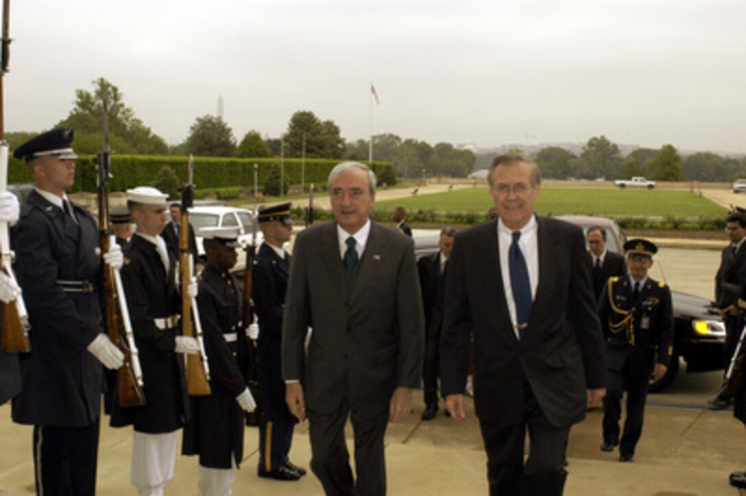 Secretary of Defense Donald H. Rumsfeld (right) escorts Italian Minister of Defense Antonio Martino through an honor cordon and into the Pentagon on May 6, 2003. Rumsfeld and Martino will meet to discuss defense issues of mutual interest. 