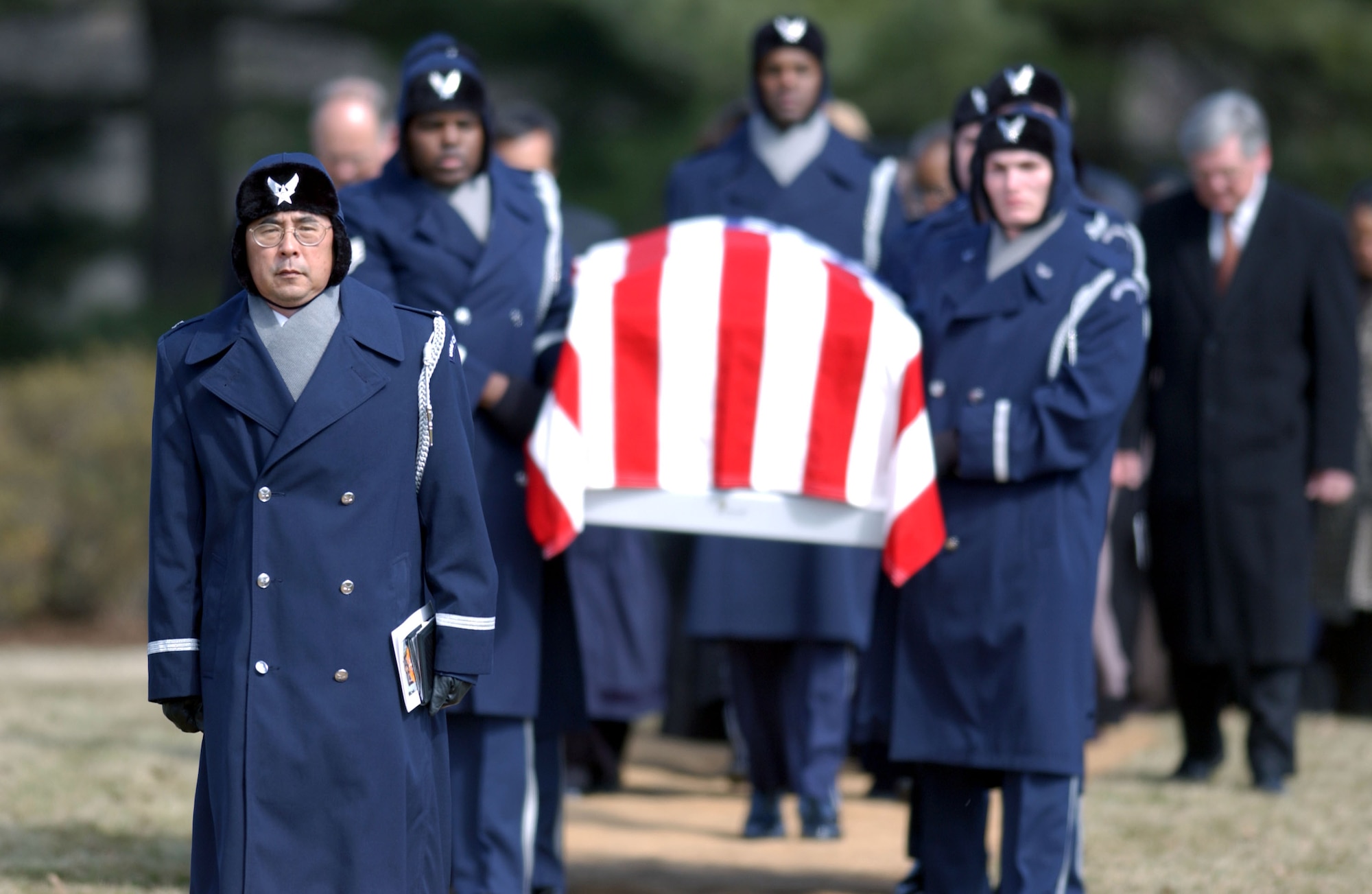 FILE PHOTO -- Chaplain (Col.) Richard K. Hum marches in front of U.S. Honor Guard members carrying the casket of shuttle astronaut Lt. Col. Michael Anderson on March 7 at Arlington National Cemetery.  (U.S. Air Force photo by Staff Sgt. Michael Holzworth)