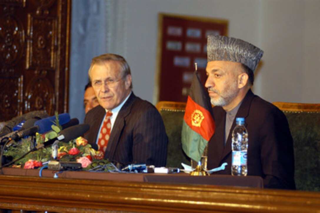 Afghan President Hamid Karzai listens as Secretary of Defense Donald H. Rumsfeld responds to a reporter's question during a media availability at the Presidential Palace in Kabul, Afghanistan, on May 1, 2003. Rumsfeld is visiting the troops and senior leadership in the Persian Gulf region. 