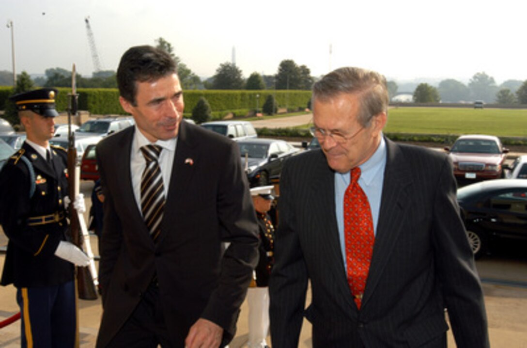 Secretary of Defense Donald H. Rumsfeld (right) escorts Danish Prime Minister Anders Fogh Rasmussen (left) into the Pentagon on May 8, 2003. The two men will meet to discuss a range of bilateral security issues. 