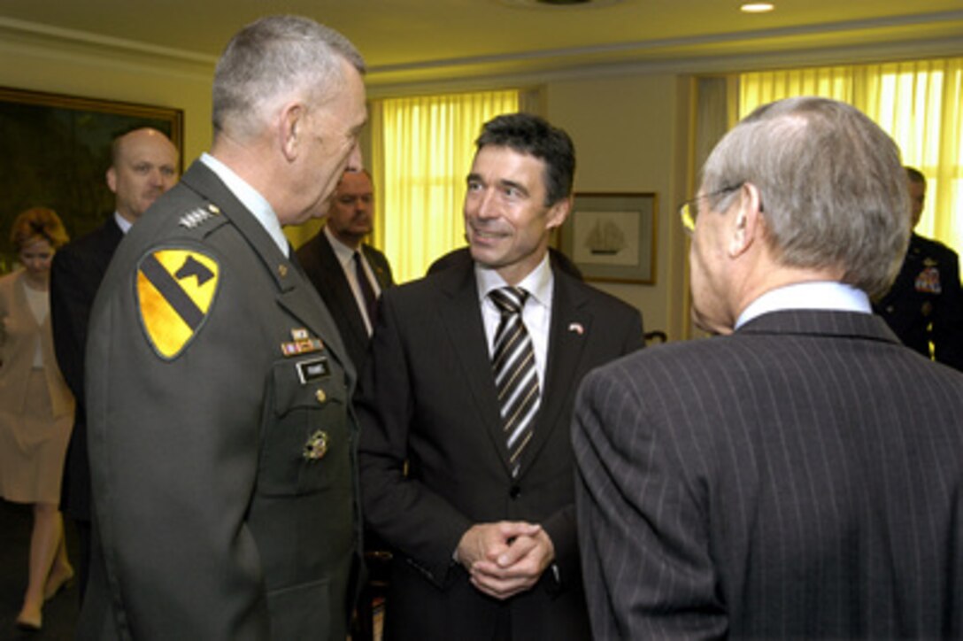 Danish Prime Minister Anders Fogh Rasmussen (center) talks with Army Gen. Tommy Franks (left) commander of U.S. Central Command, and Secretary of Defense Donald H. Rumsfeld (right) in the Pentagon on May 8, 2003. Rasmussen is meeting with Rumsfeld and his senior advisors to discuss a range of bilateral security issues and to review the progress of rebuilding and stabilizing Iraq. 