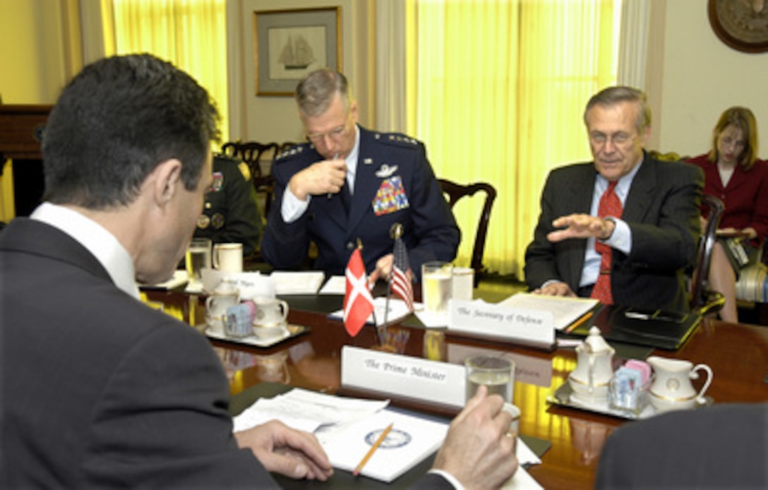 Secretary of Defense Donald H. Rumsfeld (right) hosts a meeting with Danish Prime Minister Anders Fogh Rasmussen (foreground) in the Pentagon on May 8, 2003. Rasmussen is meeting with Rumsfeld and his senior advisors to discuss a range of bilateral security issues and to review the progress of rebuilding and stabilizing Iraq. Chairman of the Joint Chiefs of Staff Gen. Richard B. Myers (center) joined Rumsfeld and Rasmussen in the meeting. 