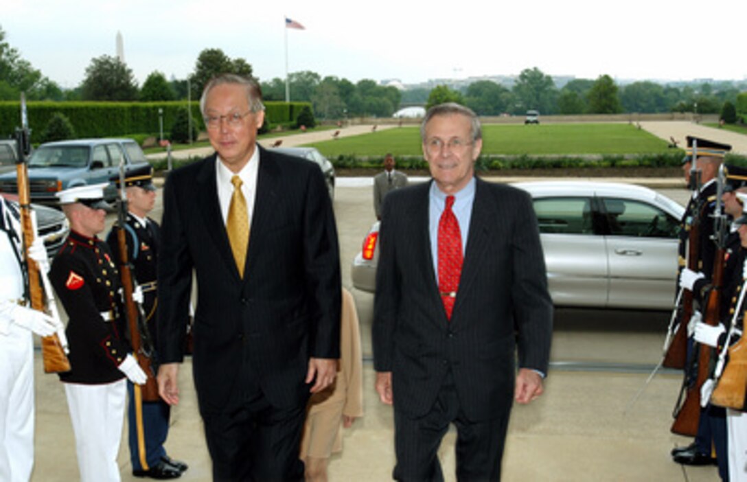 Secretary of Defense Donald H. Rumsfeld (right) escorts Singapore's Prime Minister Chok Tong Goh (left), into the Pentagon on May 8, 2003. The two men will meet to discuss a range of bilateral security issues including the continuing war on terrorism. 