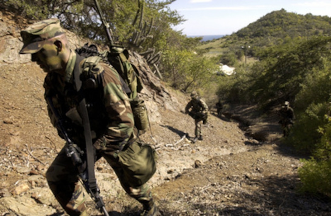 Soldiers from the Army's 166th Infantry, 2nd Battalion, Charlie Company conduct a dismounted patrol in Guantanamo Bay, Cuba. At Joint Task Force Gantanamo, the infantry provides security to the detainee compound. 