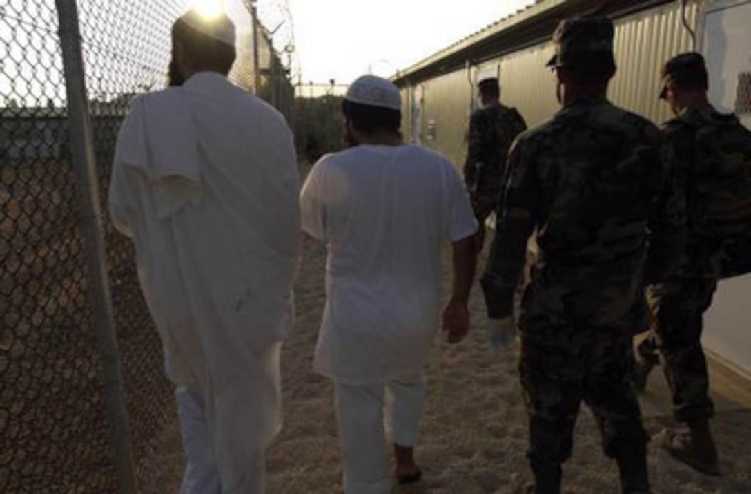 Detainees are shown to their new living quarters in a medium security facility at Guantanamo Bay, Cuba. The communal living environment allows greater freedom of movement and group recreation. 