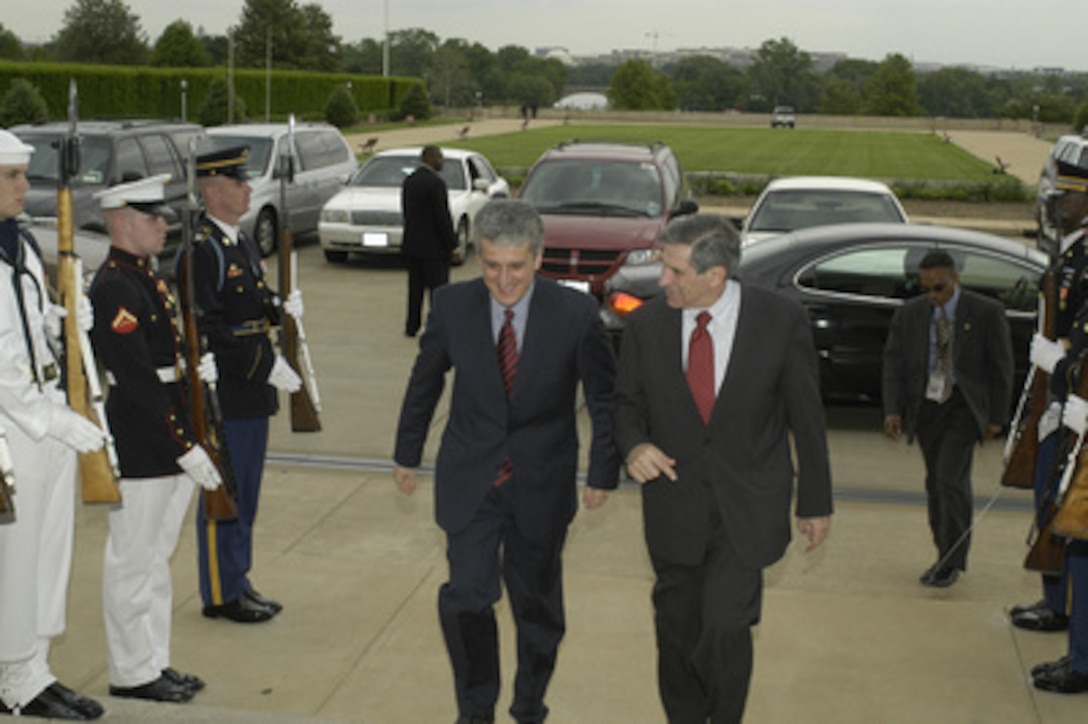 Minister of Defense of the Republic of Albania Pandeli Majko is escorted into the Pentagon by Deputy Secretary of Defense Paul Wolfowitz on May 12, 2003. The two leaders are meeting to discuss defense issues of mutual interest. 