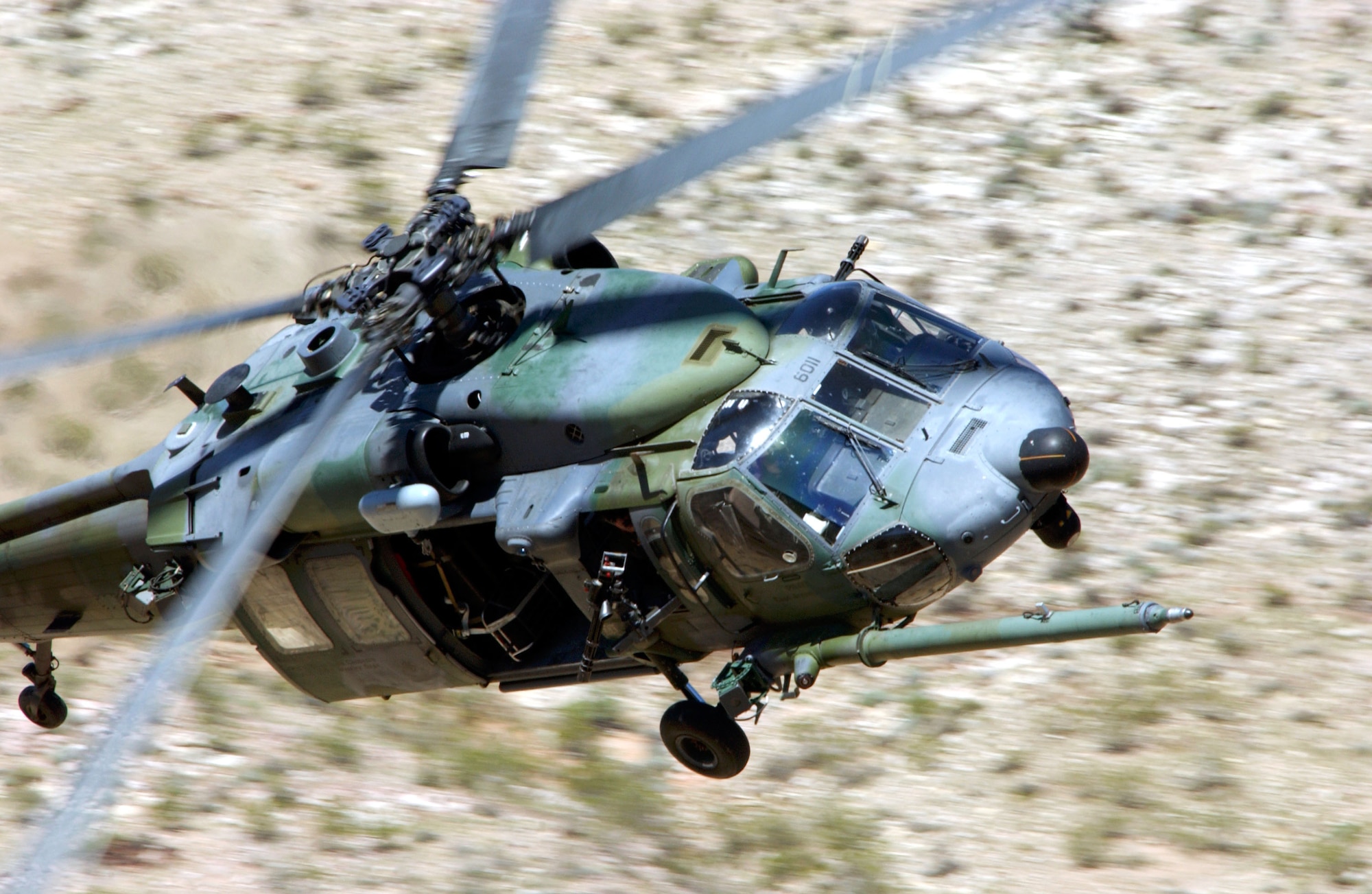 NELLIS AIR FORCE BASE, Nev. -- A HH-60G Pave Hawk from the 66th Rescue Squadron, Nellis Air Force Base, Nev., flies over the desert terrain of southern Nevada during a training mission.  The 66th Rescue Squadron's primary mission is the recovery of downed pilots and is one of only five active duty rescue squadrons in the Air Force.   (U.S. Air Force photo by Tech. Sgt. Robert W. Valenca)