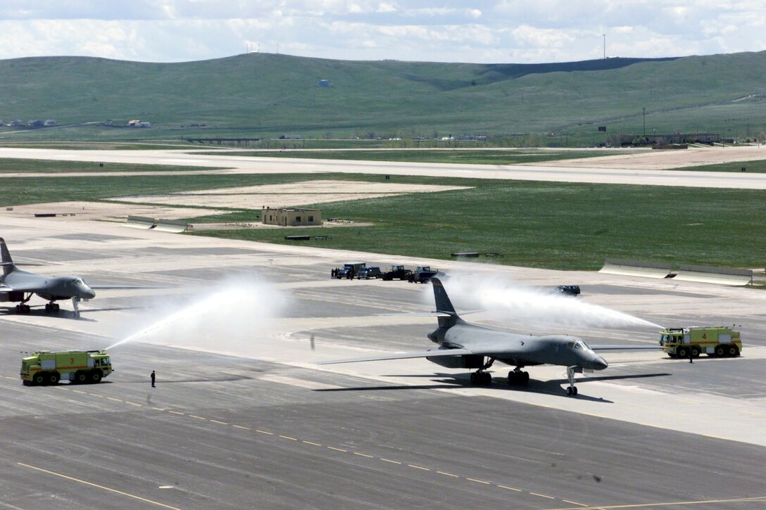 ELLSWORTH AIR FORCE BASE, S.D. -- Base firefighters welcome home B-1 Lancer crews here May 13.  Six B-1s and their crews return to a crowd of family and friends welcoming them home.  As of May 8, B-1s flew 497 combat sorties supporting operations Enduring Freedom and Iraqi Freedom and dropped 4.56 million pounds of munitions.  (U.S. Air Force photo by Airman 1st Class Karah McNeill)