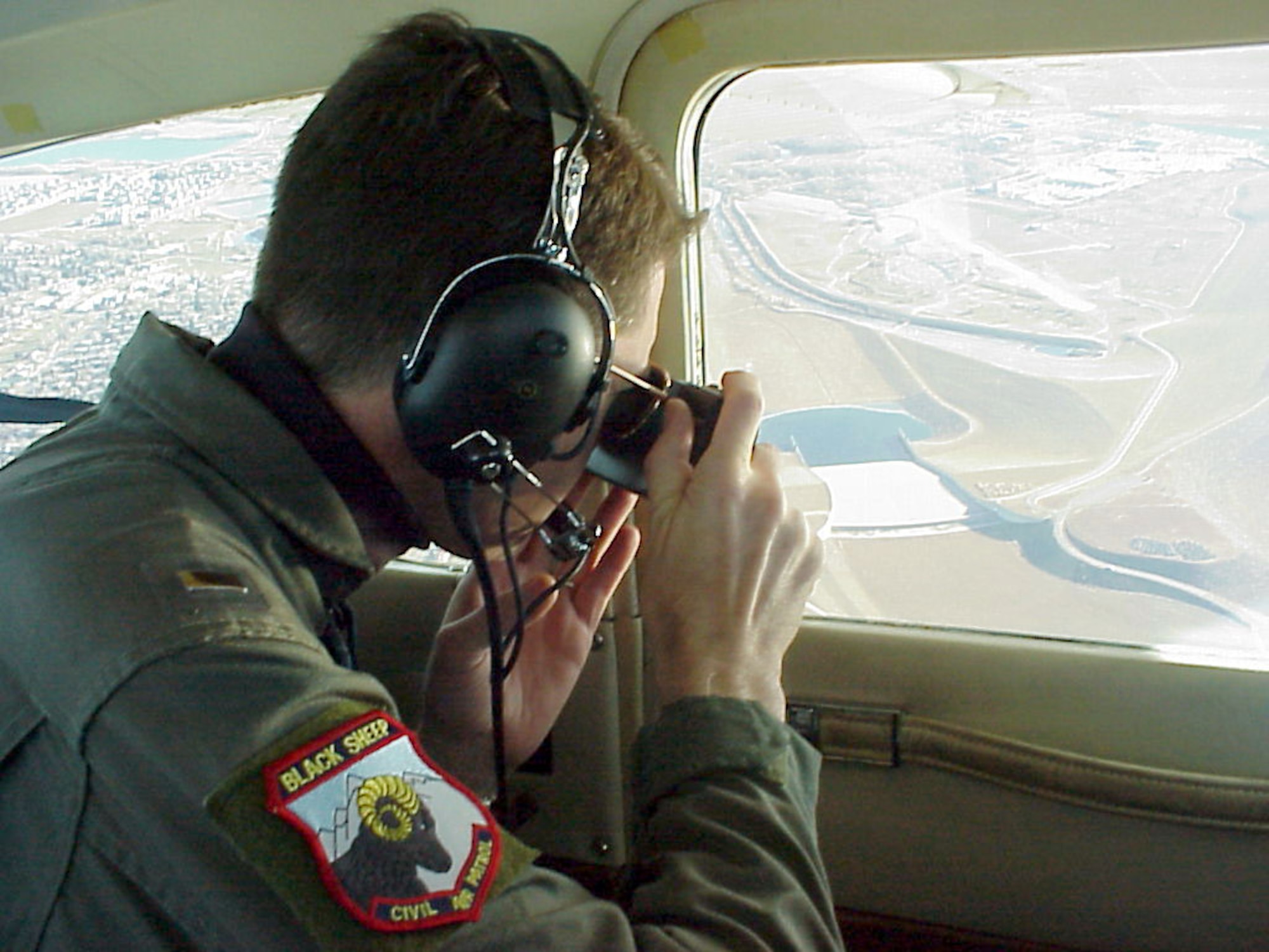 OVER COLORADO -- First Lt. Chad Morris of the Civil Air Patrol's Colorado wing photographs a sports utility vehicle from 1,000 feet during a homeland security mission simulation.  After receiving a rough location, Morris and his crew established Global Positioning System coordinates, flew to the spot and started the search for the "suspicious" vehicle.  (U.S. Air Force photo by Melanie LeMay)