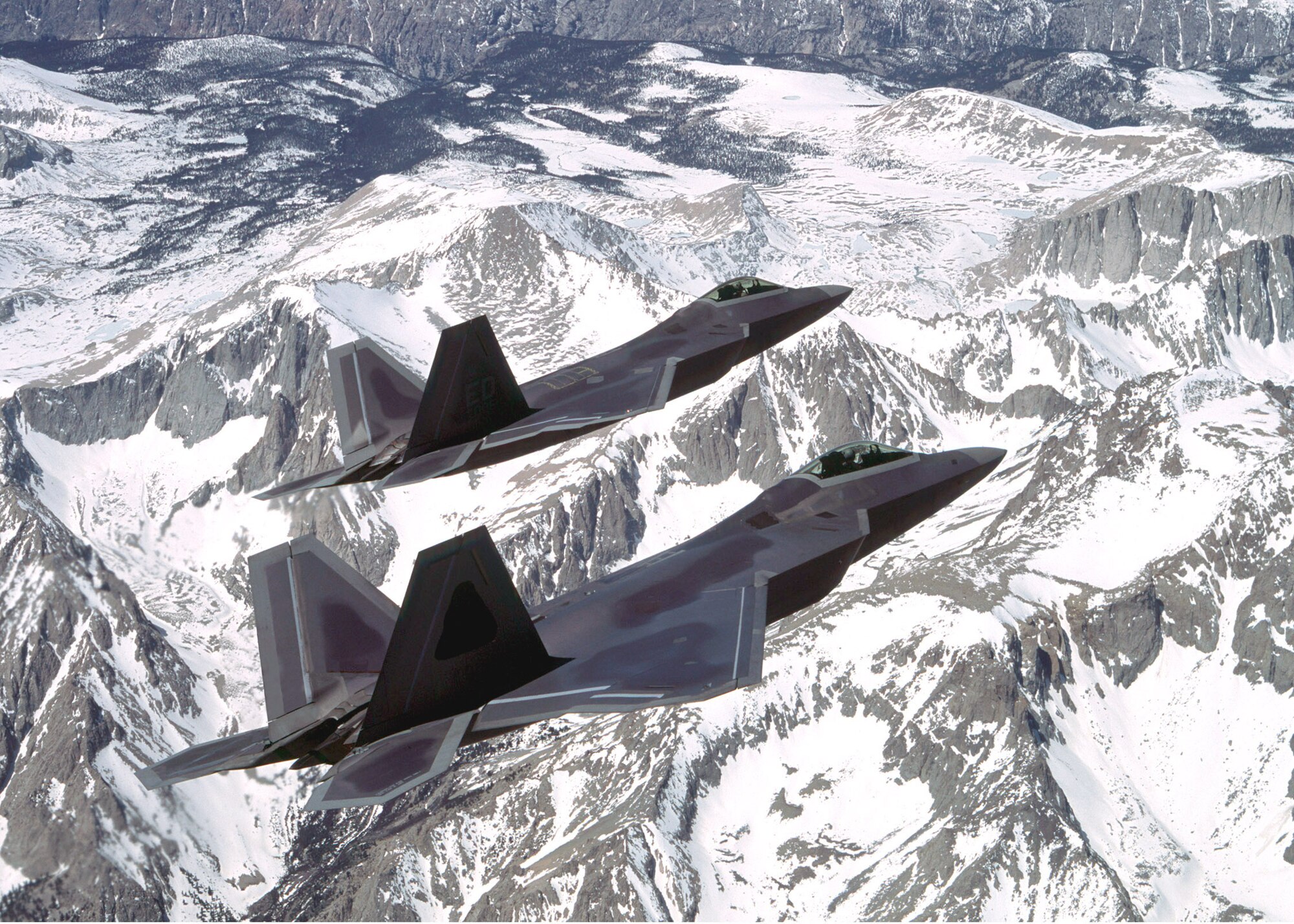 EDWARDS AIR FORCE BASE, Calif. -- Two F/A-22 Raptors based here undergo developmental flight testing recently.  The Air Force negotiated the procurement of one additional Raptor as part of a recent purchase, raising the total to 21 aircraft.  (Courtesy photo)