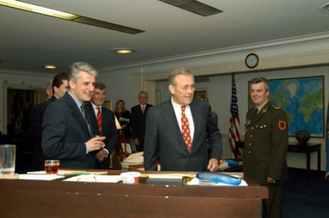 Secretary of Defense Donald H. Rumsfeld (center) gives a tour of his Pentagon office to Albanian Minister of Defense Pandeli Majko (left) and members of his delegation on May 14, 2003. From left to right: Minister Majko; Ambassador to the U.S. Fatos Tarifa (red tie); Rumsfeld; and Albanian Defense AttachÇ to U.S. Col Viktor Isaku. 