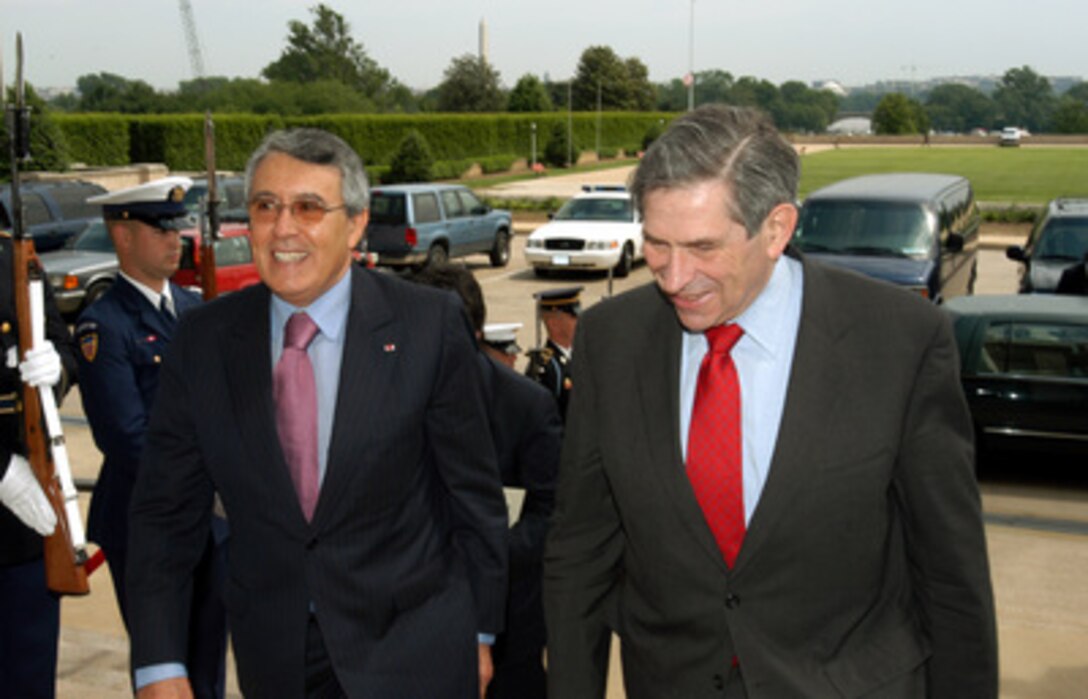 Deputy Secretary of Defense Paul Wolfowitz (right) escorts Moroccan Minister of Foreign Affairs and Cooperation Mohamed Benaissa (left) into the Pentagon on May 15, 2003. The two men will meet to discuss bilateral and regional security issues. 
