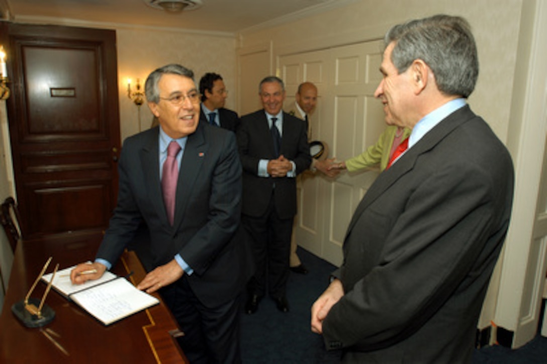 Moroccan Minister of Foreign Affairs and Cooperation Mohamed Benaissa (left) prepares to sign the guest book of Deputy Secretary of Defense Paul Wolfowitz (right) in the Pentagon on May 15, 2003. The two men will meet to discuss a range of bilateral and regional security issues. 