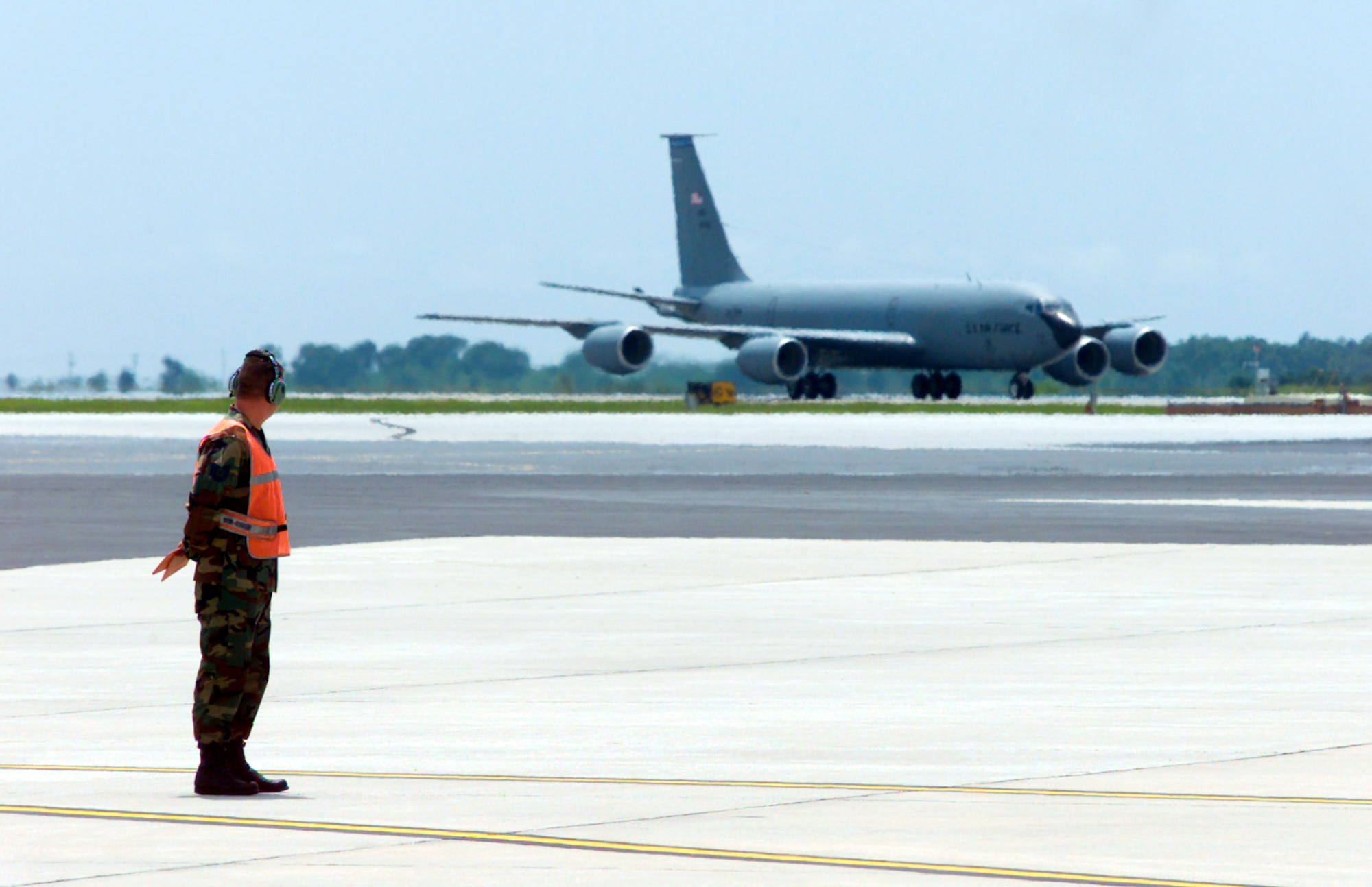 MACDILL AIR FORCE BASE, Fla. (AFPN) -- Tech. Sgt. Christopher White waits to marshal in a KC-135E Stratotanker returning from Southwest Asia.  An Air Force plan to replace aging KC-135s with leased 767s is currently under review by the Department of Defense. White is a crew chief in the 6th Aircraft Maintenance Squadron here.  (U.S. Air Force photo by Tech. Sgt. Douglas K. Lingefelt)
