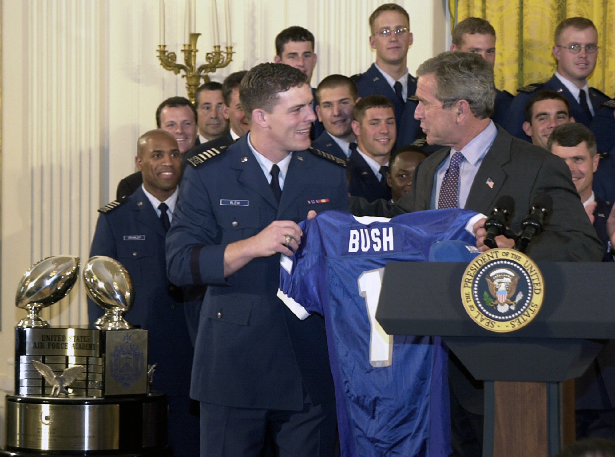 WASHINGTON -- Air Force Academy Cadet 1st Class Bryan Blew presents President Bush with a personalized football jersey during the Commander-in-Chief's Trophy ceremony May 16 in the White House.  (U.S. Air Force photo by Staff Sgt. A. J. Bosker)