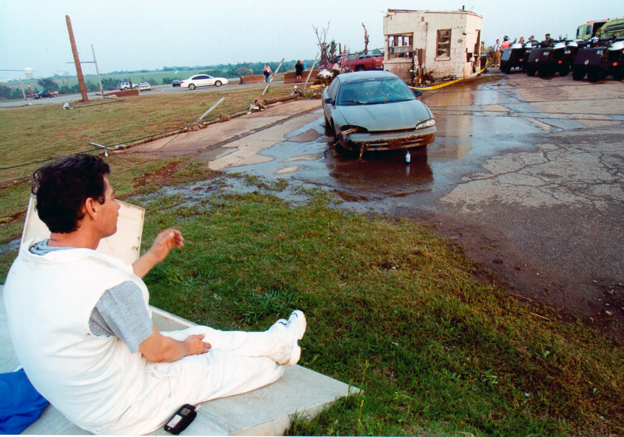 TINKER AIR FORCE BASE, Okla. (AFPN) -- A stunned Antonio Burciaga looks at his wrecked car and considers what his fate might have been if a 72nd Security Forces airman had not forced him to abandon his vehicle and take shelter in a storm cellar here during a tornado.  (U.S. Air Force photo by Margo Wright)