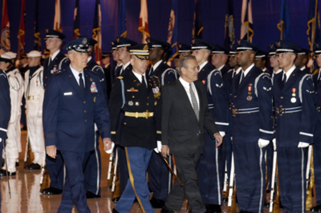 Secretary of Defense Donald H. Rumsfeld (right) and Chairman of the Joint Chiefs of Staff Gen. Richard B. Myers (left), are escorted by Army Col. James F. Laufenberg (center) as they inspect the joint services honor guard during opening ceremonies of the Joint Armed Forces Open House and Air Show at Andrews Air Force Base, Md., on May 16, 2003. The open house affords the public the opportunity to meet some of the men and women serving in our military forces and examine the latest military aircraft, combat vehicles and weapons systems. 