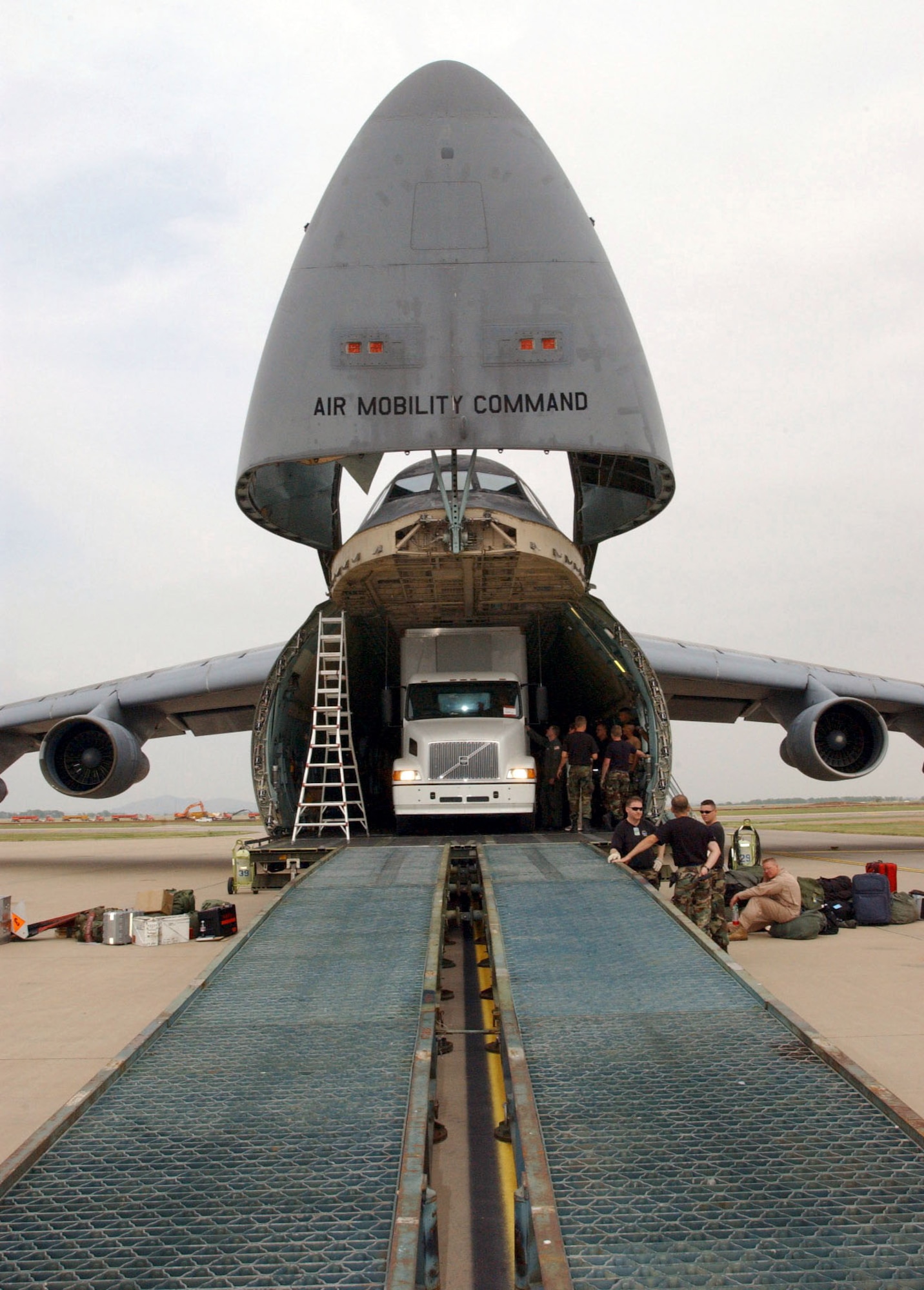 ALTUS AIR FORCE BASE, Okla. -- Crews from the 97th Air Mobility Wing here and the 60th AMW at Travis Air Force Base, Calif., load a semitrailer carrying humanitarian cargo into a C-5 Galaxy for delivery to a forward-deployed location supporting Operation Iraqi Freedom.  With clearance coming as close as 4 inches at one point, the trailer took about five hours to load using a Minuteman Missile ramp.  The C-5 is assigned to the 60th AMW.  (U.S. Air Force photo by Airman 1st Class Kristi Hare)