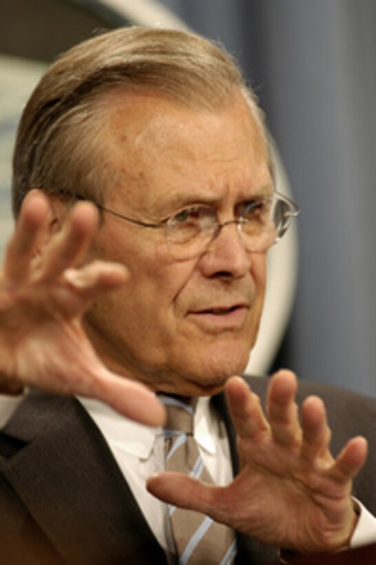Secretary of Defense Donald H. Rumsfeld tells reporters about the contributions of coalition members in restoring the damaged infrastructure in Iraq during a May 20, 2003, Pentagon press briefing. Chairman of the Joint Chiefs of Staff Gen. Richard B. Myers, U.S. Air Force, joined Rumsfeld for the briefing. 