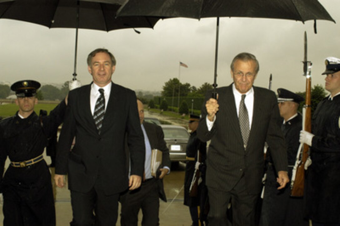 Secretary of Defense Donald H. Rumsfeld (right) escorts Britain's Secretary of State for Defence Geoffrey Hoon through an honor cordon and into the Pentagon on May 21, 2003. Rumsfeld and Hoon will meet to discuss a range of defense issues of mutual interest. 