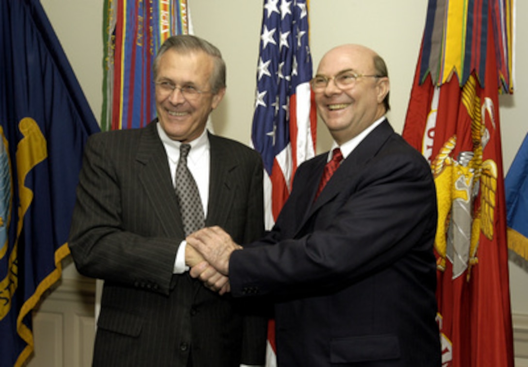 Secretary of Defense Donald H. Rumsfeld (left) and Dominican Republic President Rafael Hipolito Mejia Dominguez pose for photos in the Pentagon on May 21, 2003, before sitting down to discuss a broad range of bilateral and regional security issues. 