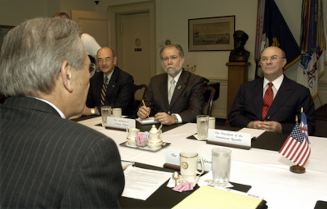 Dominican Republic President Rafael Hipolito Mejia Dominguez (right) meets with Secretary of Defense Donald H. Rumsfeld (foreground) in the Pentagon on May 21, 2003. Dominican Secretary of Foreign Affairs Francisco Guerrero Prats (center) and Secretary of Tourism Rafael Subervi Bonilla (left) joined in the discussion of bilateral and regional security issues. 
