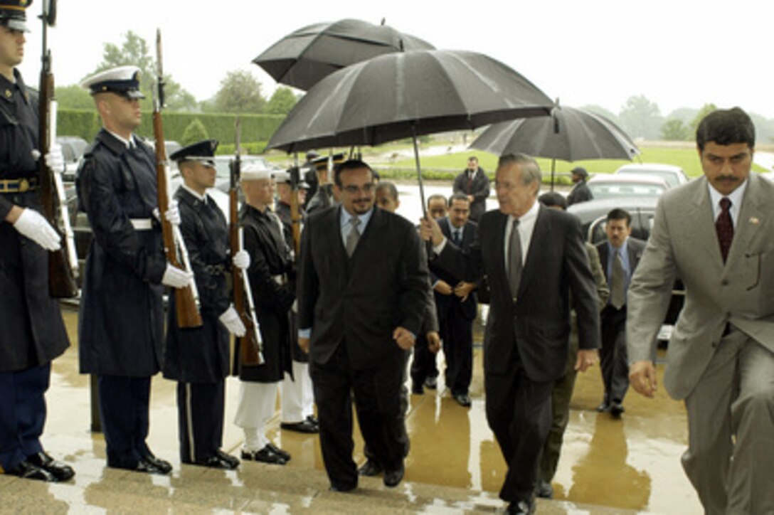 Secretary of Defense Donald H. Rumsfeld (right) escorts Bahrain's Crown Prince Salman bin Hamad Al-Khalifa through an honor cordon and into the Pentagon on May 21, 2003. The two defense leaders will meet to discuss regional security issues of mutual interest. 