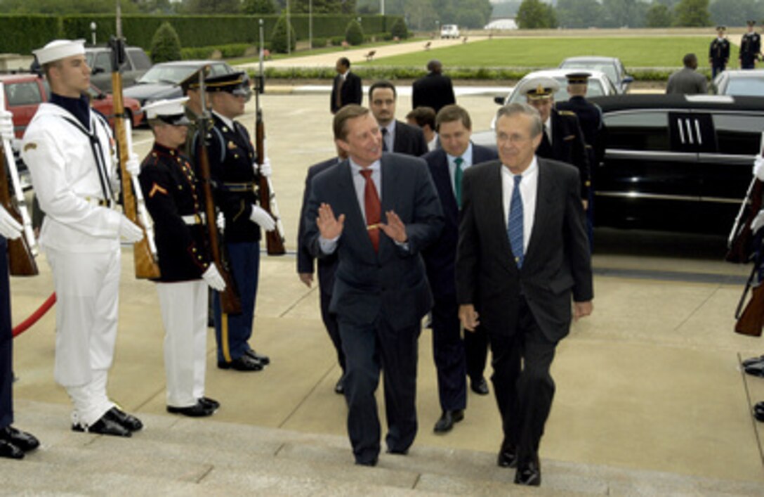 Secretary of Defense Donald H. Rumsfeld (right) escorts Russian Minister of Defense Sergey Ivanov through an honor cordon and into the Pentagon on May 22, 2003, for a working luncheon. The two defense leaders will discuss a broad range of bilateral security issues. 