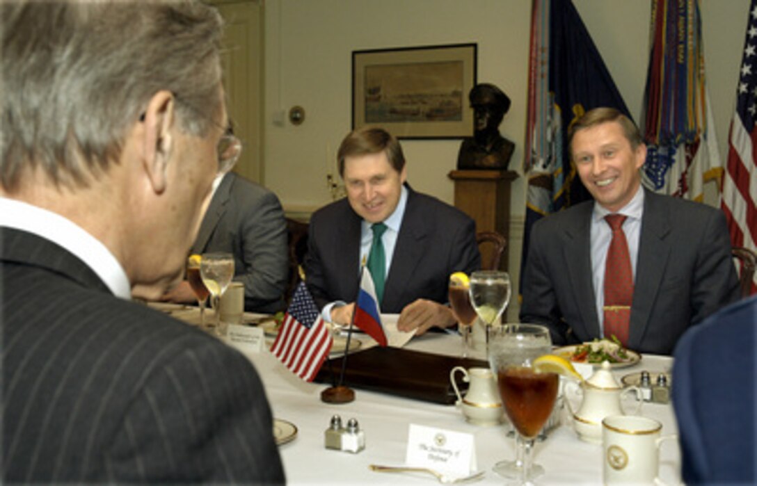 Russian Minister of Defense Sergey Ivanov (right) is the guest of honor at a working lunch hosted by Secretary of Defense Donald H. Rumsfeld (foreground) in the Pentagon on May 22, 2003. Russian Ambassador to the U.S. Yuriy Ushakov (center) joined Ivanov and Rumsfeld to discuss a broad range of bilateral security issues. 
