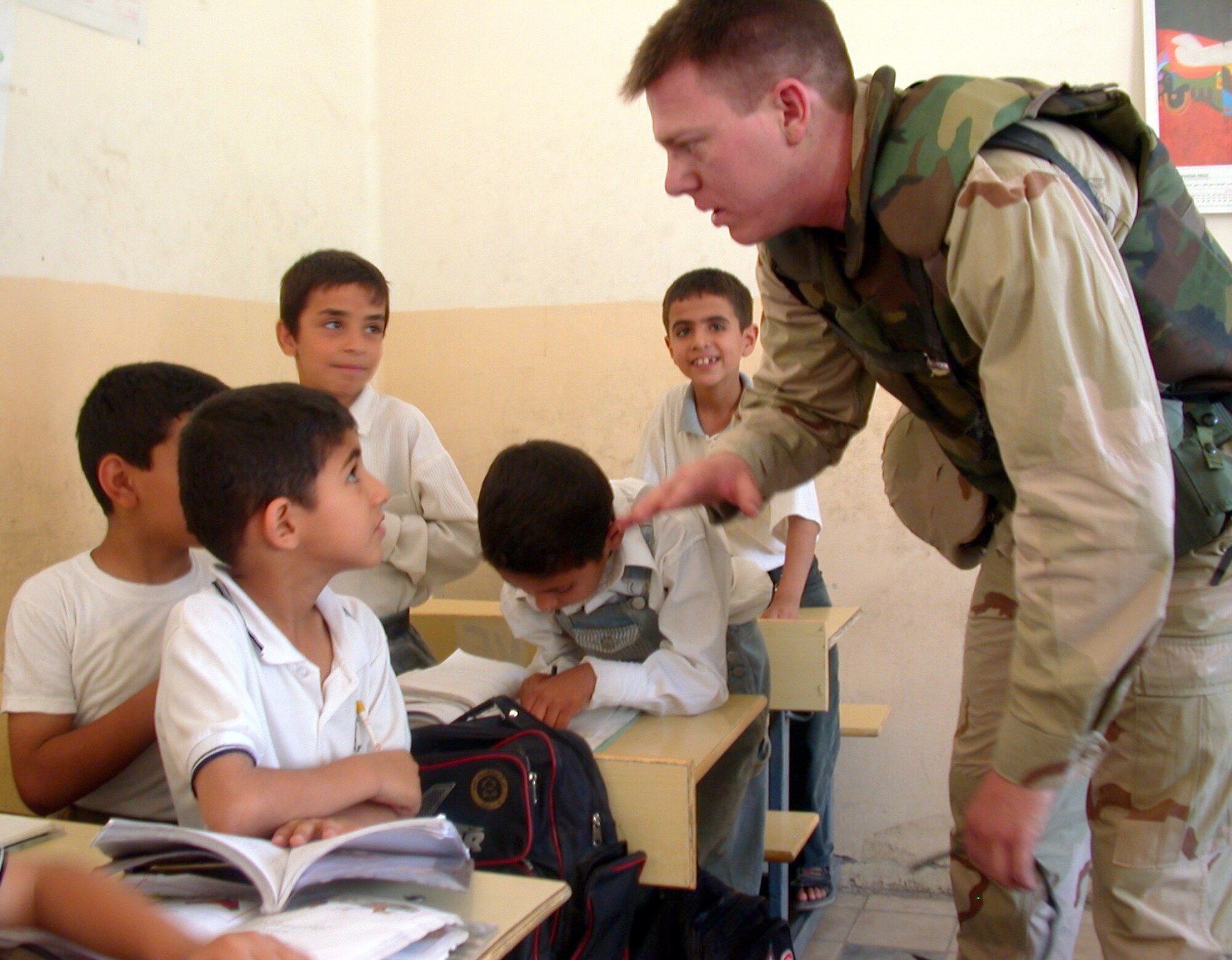 OPERATION IRAQI FREEDOM -- Second Lt. Brandon Stewart talks with Iraqi students during a recent humanitarian trip to their school in Baghdad.  Stewart is assigned to the 380th Air Expeditionary Wing at a forward-deployed location.  (U.S. Air Force photo by Capt. David P. Lester)