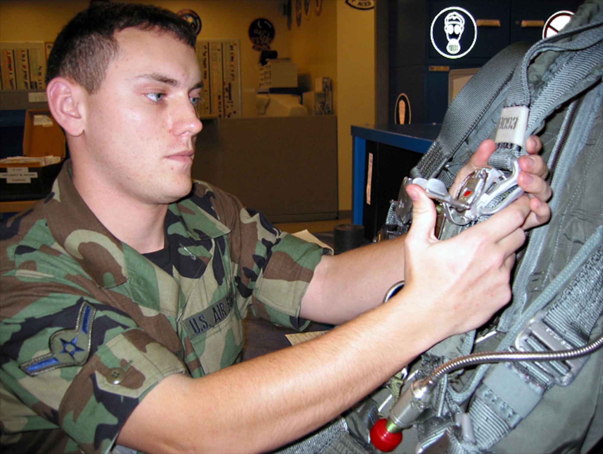LAUGHLIN AIR FORCE BASE, Texas -- Airman Jacob Pegg, a life support technician here, inspects a parachute.  Last year, the life support team conducted about 35,000 regular equipment inspections.  Adding support to the T-6 Texan crews, the team expects to top 40,000 inspections this year.  (U.S. Air Force photo by Airman 1st Class Yvonne Conde)