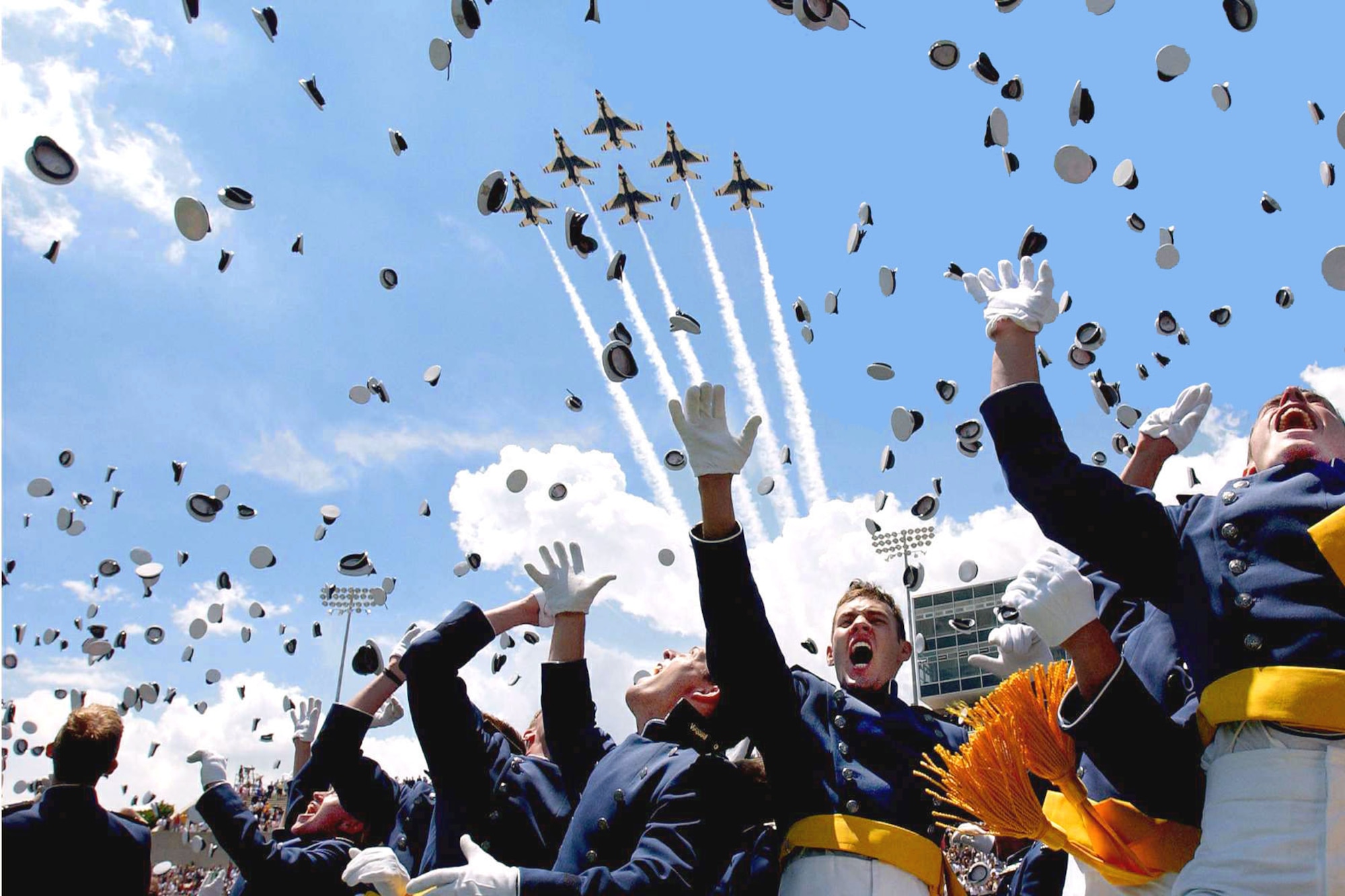 U.S. AIR FORCE ACADEMY, Colo. -- Cadets of the Air Force Academy Class of 2003 celebrate at graduation ceremonies here May 28 as the Air Force Thunderbirds fly overhead.  The 974 students marked the academy's 45th graduating class.  (U.S. Air Force photo by Danny Myers)